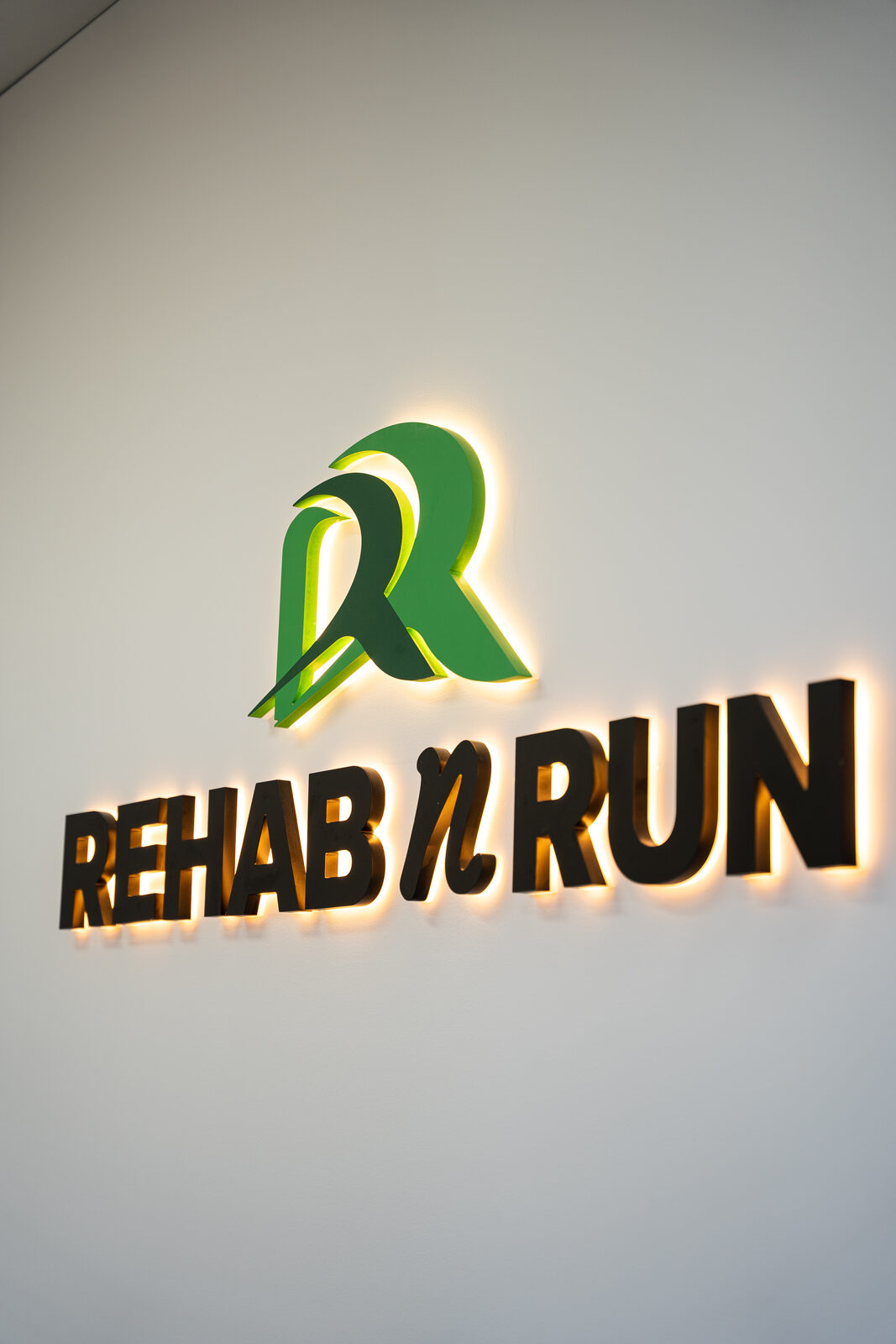 The illuminated Rehab N Run logo inside the Liverpool clinic